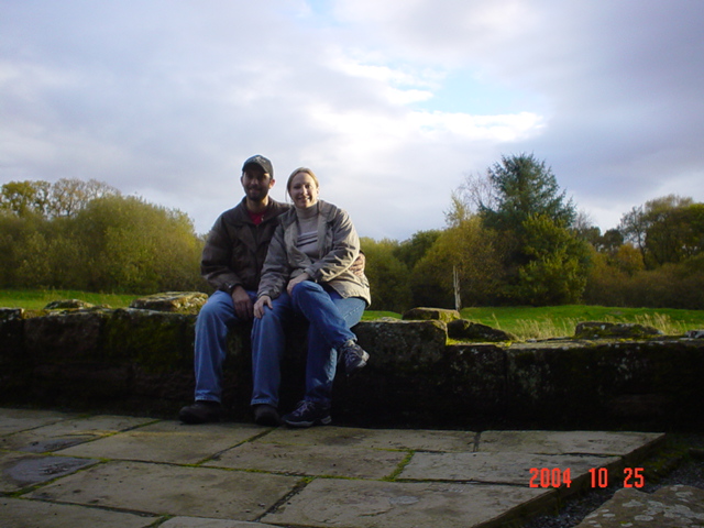 Mickey and Carrie sitting on the back wall of Caerlaverock Castle