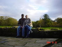 Mickey and Carrie sitting on the back wall of Caerlaverock Castle